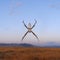 Orb weaver spider suspended against blue sky