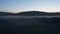 Orbit aerial view of foggy and misty highlands at sunset in Iceland. Stunning moonscape panorama of moody autumnal