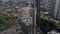 Orbit shot around tall modern building in process of construction. Tower crane on construction site. Aerial view of