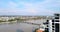 Orbital drone shot revealing Kampot town with the old French  bridge over a river