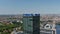 Orbiting around top of tall modern building with advertisement. Aerial view of urban neighbourhood. Berlin, Germany