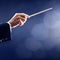 Orchestra conductor hand conducting