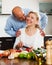 Ordatary mature couple cooking together