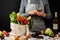 Order food online. Purchases concept. Grocery eco bag with fresh healthy food and a woman holds smartphone in hands