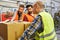 Order pickers and colleagues check cardboard boxes in shipping