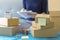 Order, Stack of packing box, Shipping parcel package and delivery shopping online. Woman writes and check packing list order