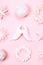 Orderly rows of nine white beautiful christmas toys on pink pastel background.