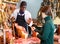 Ordinary butcher offering Spanish ham to client