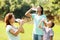 Ordinary family of three drinking from bottles