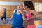 Ordinary female is fighting with trainer on the self-defense course for woman in sport club