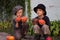 Ordinary kids sitting with Halloween pumpkins