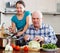 Ordinary mature couple cooking with vegetables