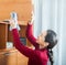 Ordinary woman cleaning wooden furniture