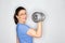 Ordinary woman lifting weights dumbbell