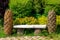 Ordinary wooden bench with figures in the form of cones in the park.