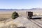 Ore cart sitting on tracks overlooking a desert valley