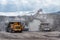 Ore loading with a powerful excavator. Loading a large mining truck.