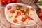 Orecchiette pasta with arugula and tomato.