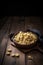 Orecchiette pasta in a bowl on wooden background