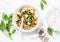 Orecchiette pasta with spinach and pumpkin - vegetarian lunch on white background