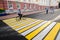 Orel, Russia, August 05, 2017: City Day. Bearded man riding bicycle on empty zebra crossing