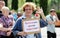 Orel, Russia, June 12, 2017: Russia protests. Smiling senior woman with banner Pensioners against corruption