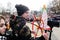 Orel, Russia, March 10, 2019: Maslenitsa selebration. Reporter shooting crowd of people with Lady Maslenitsa on background