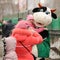 Orel, Russia - March 13, 2016: Maslenitsa, Pancake festival. Woman taking photo of child with cow doll