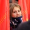 Orel, Russia - November 7, 2015: Communist party meeting. Communist girl with red flags. Smiling girl.