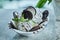 Oreo ice-cream with chocolate syrup and mint in the white plate on the marble background