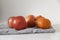 Organic apples and tangerines over a gray kitchen towel