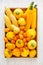 Organic assorted yellow vegetables in wooden tray. Healthy eating concept. Top view