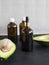 Organic avocado oil in a dark glass bottle with a pipette. Serum in glass bottle with pipette on black and white background. 