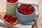 Organic berries red strawberries in ceramic bowl and wooden spoon