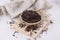 Organic black wild rice on a rustic ceramic plate on a white wooden background