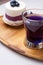 Organic Butterfly pea, clitoria or Blue pea flower herbal tea. Thai blue tea. served with   blueberry cake on wooden tray. close