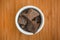 Organic Cacao Paste in a bowl on a wooden background