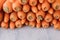 Organic carrots piled together on wooden background. Close up view. Natural carrots at the market ready to eat.