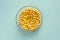 Organic chickpea soaked in water in a bowl on a blue background