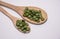 Organic chlorella and spirulina pills and wooden scoop.Selective focus