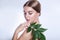 Organic cosmetic . Beautiful woman face portrait with green leaf , concept for skin care or organic cosmetics