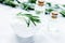 organic cosmetics with rosemary extract on stone table backgroun