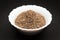 Organic Cumin seed in ceramic bowl.