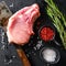 Organic cutlet on a rib or Pork meat over american classic butcher knife or cleaver with spices and rosemary and red pepper on