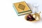Organic dried dates traditional arabic golden plate, cup pure drinking water and quran book. Ramadan concept. Copy space