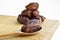 Organic dried hurma dates medjool grains, in wooden spoon on cutting board