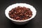 Organic Dried Pomegranate seeds in ceramic bowl.