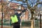 Organic ecological agriculture. Defocus farmer man spraying tree with manual pesticide sprayer against insects in spring garden.