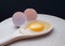 Organic eggs broken and yolk egg in wooden spoon on a Chopping Wood