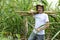 Organic farmer carrying sugar cane